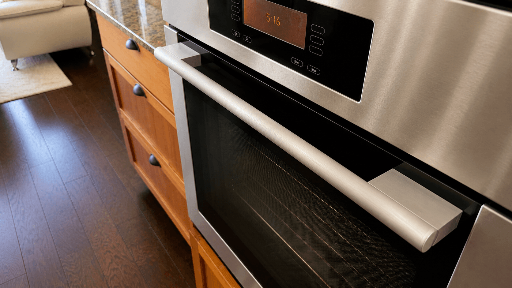 An oven door restored from streaked glass to a clean finish